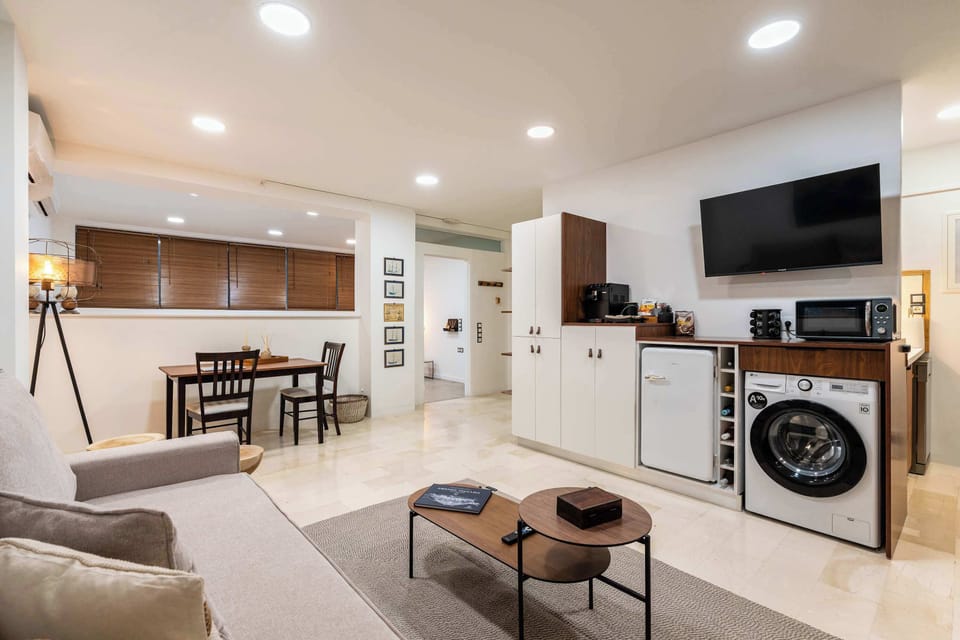 The living, dining, and kitchen areas flow naturally together, creating a comfortable and practical space for couples, friends, and families.