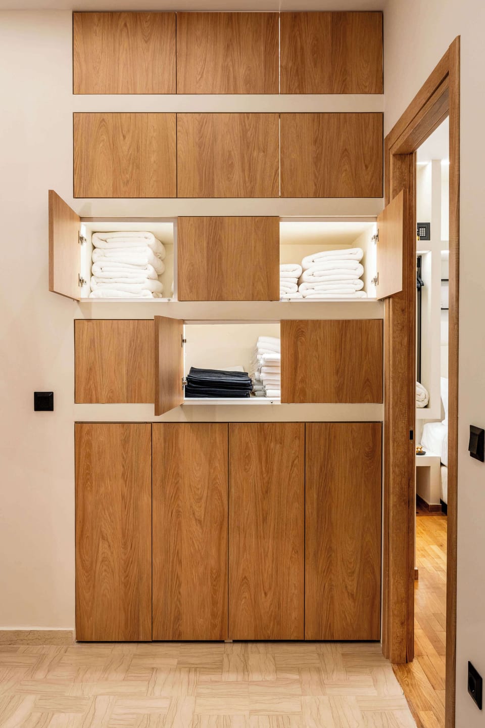 Warm wood tones and contemporary finishes create a welcoming atmosphere that connects naturally with the apartment's living spaces.
