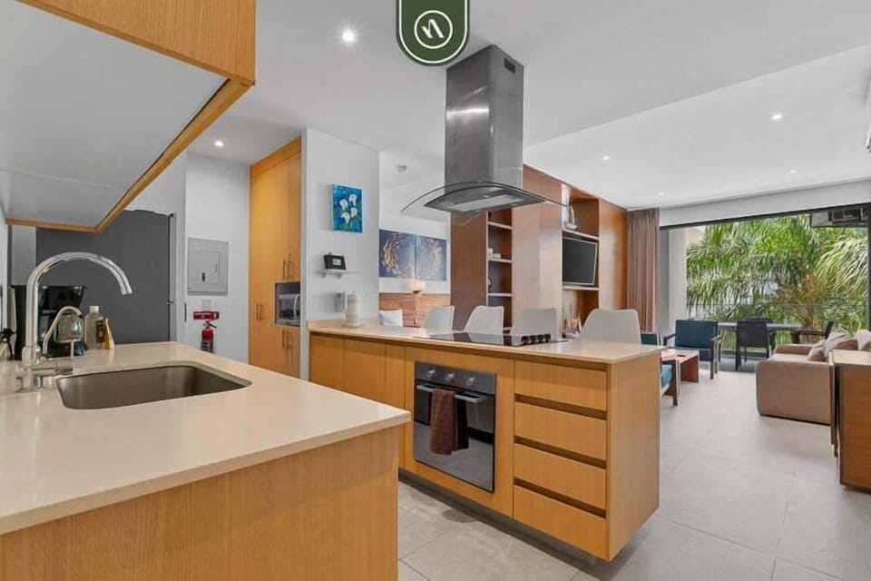 Bright open-concept kitchen with modern finishes, spacious counters, and a sleek island. Flows seamlessly into the living area and balcony, creating a comfortable space for cooking, dining, and relaxing.