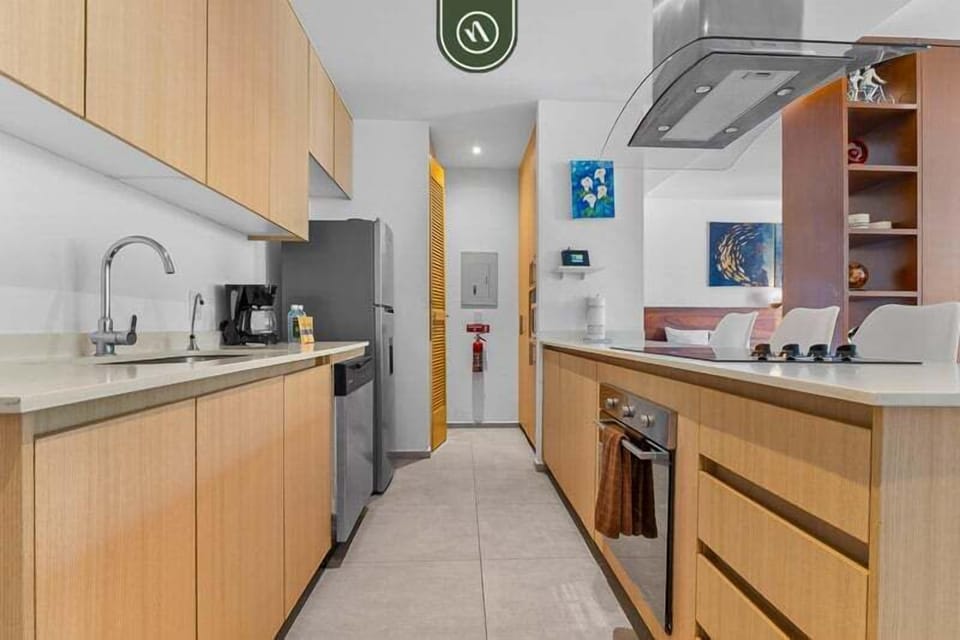 Sleek and functional kitchen with modern appliances, ample counter space, and clean design. Perfect for preparing meals comfortably during your stay.