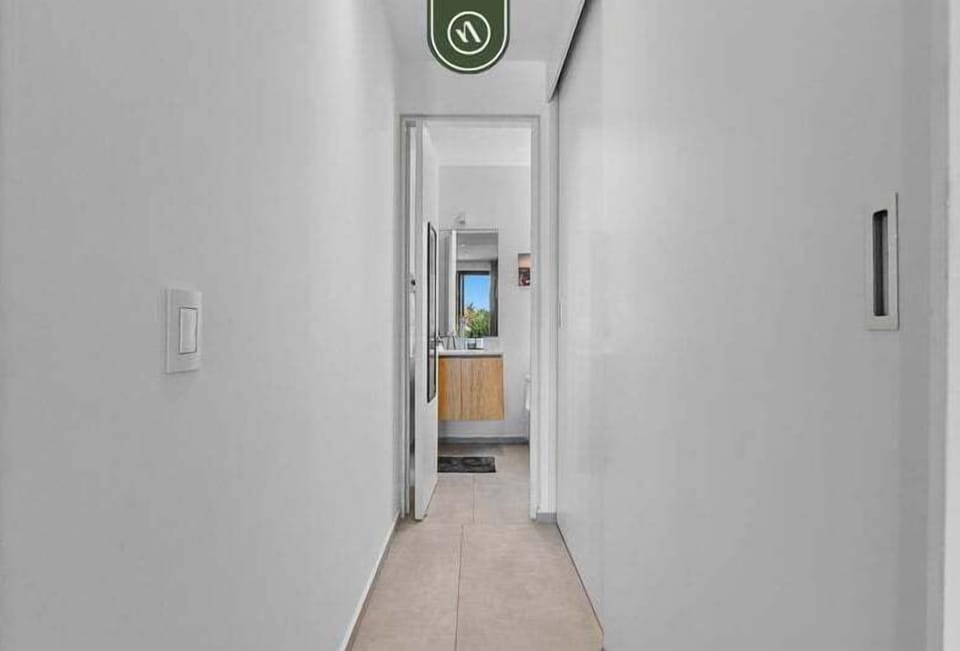 Clean and modern bathroom with sleek finishes, a walk-in shower, and a stylish vanity. Bright and functional, offering comfort and convenience during your stay.