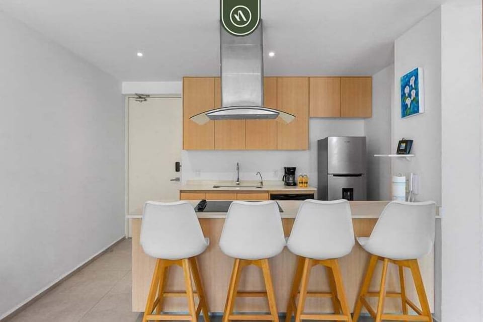 Modern kitchen with clean finishes, fully equipped appliances, and a stylish breakfast bar with seating. Perfect for casual meals, morning coffee, or socializing while cooking.