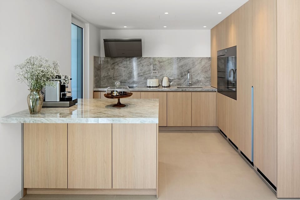 The fully equipped kitchen is a culinary sanctuary, featuring opulent quartz finishes and state-of-the-art Miele and Smeg appliances, elevating your cooking experience