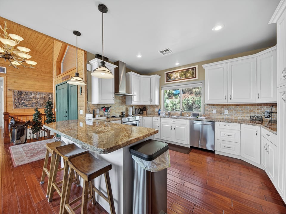 You'll love cooking in this spacious, sunlit kitchen with granite countertops, modern appliances, and a welcoming island perfect for morning coffee or gathering with loved ones.