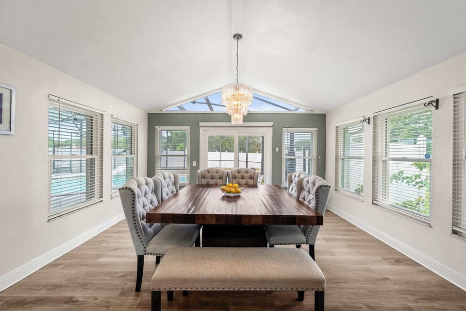 Bright sunlit dining room with pool views & skylight