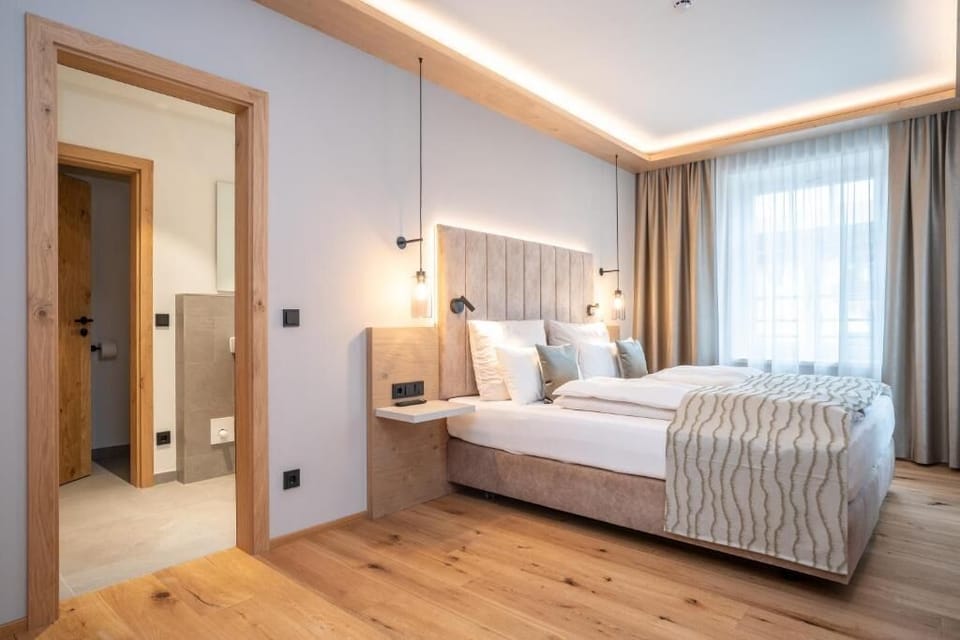 Deluxe Suite, Partial Lake View | In-room safe, desk, blackout drapes, free WiFi