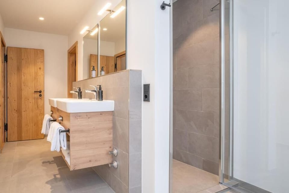 Deluxe Suite, Partial Lake View | Bathroom | Shower, hair dryer, towels, soap