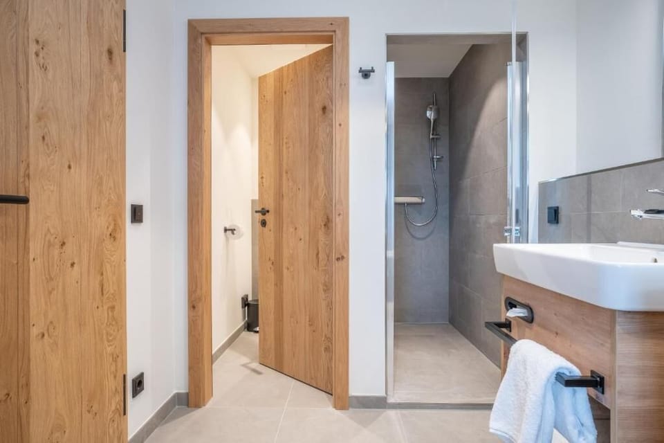 Suite, Partial Lake View | Bathroom | Shower, hair dryer, towels, soap