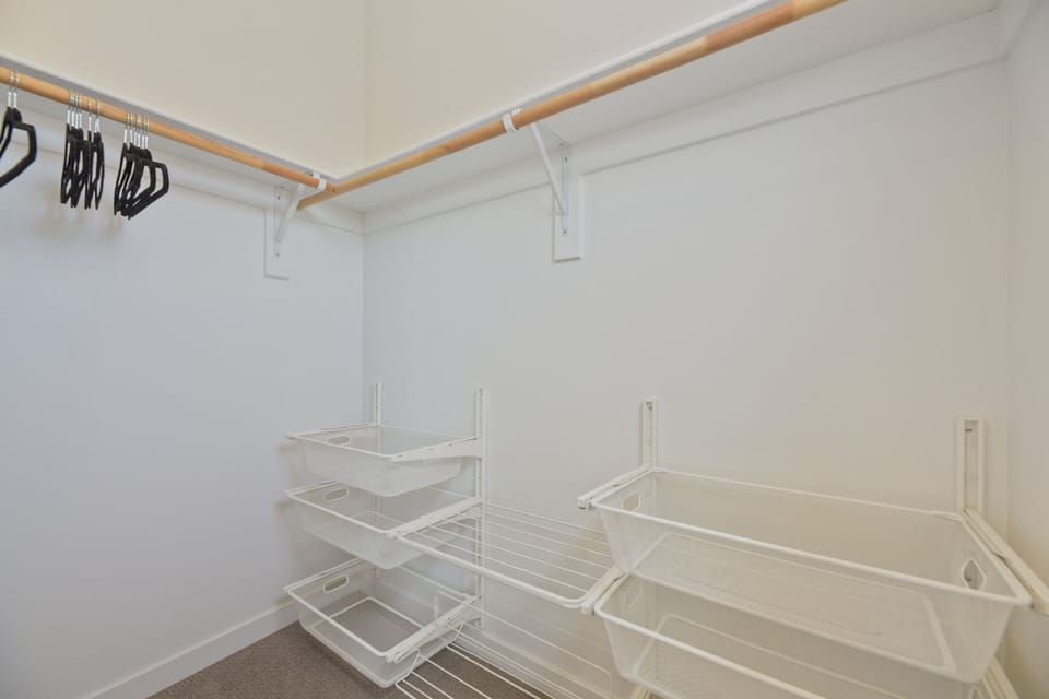 Your spacious walk-in closet features sturdy hanging rods and clever wire shelving, giving you plenty of room to unpack and settle in comfortably.