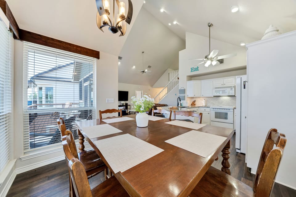 A dining area that continues outside with a beautiful view of the lake.