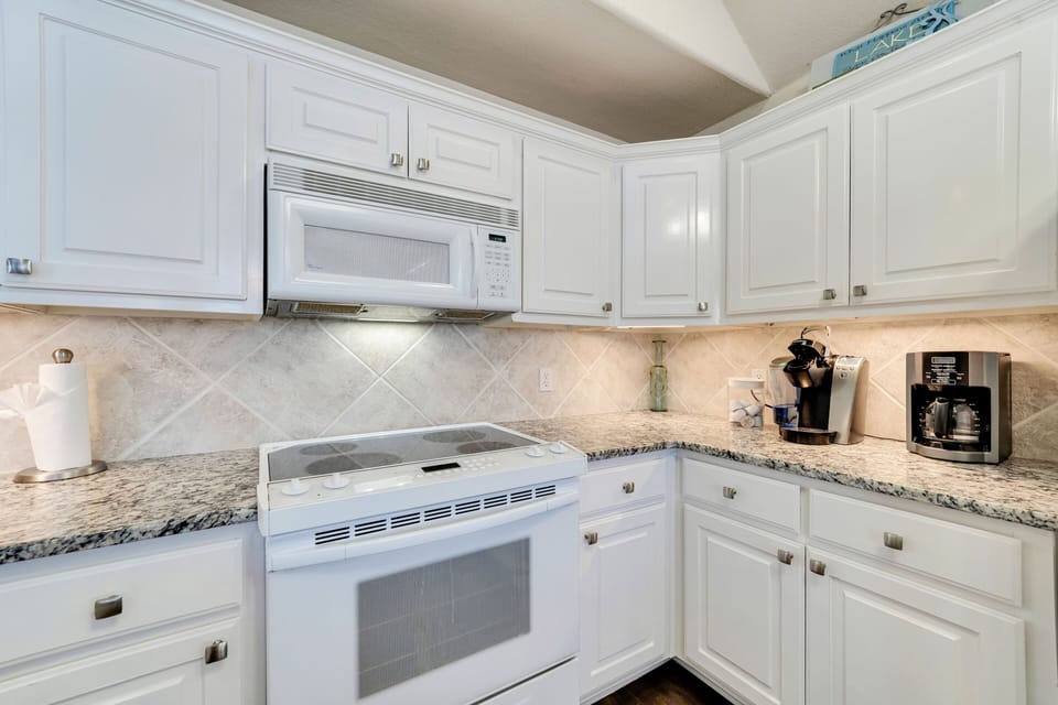 Full kitchen open to the family room with a drip coffee maker and a Keurig.