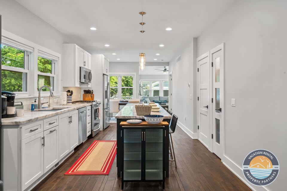 A bright, well-equipped kitchen with island seating, clean finishes, and plenty of space for preparing meals during your stay.