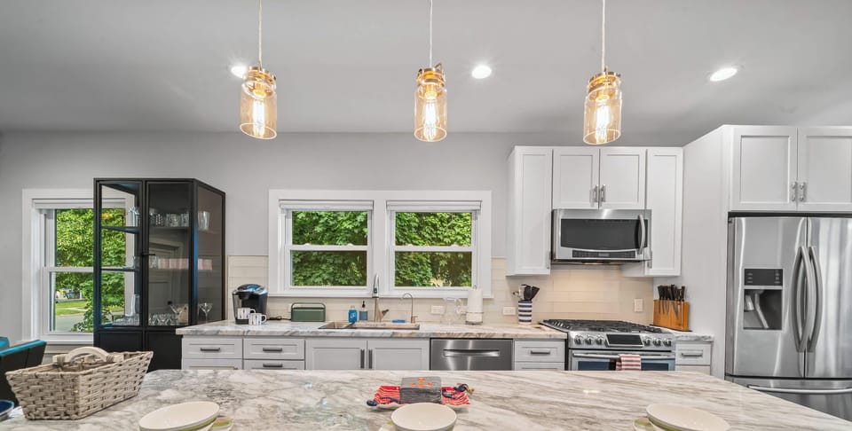 Cook, gather, and snack around the spacious kitchen island with modern appliances, bright windows, and everything you need for easy meals at home.