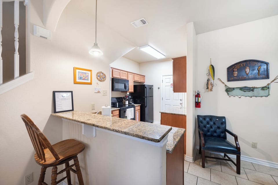 Settle into your fully equipped kitchen with granite countertops, modern appliances, and a welcoming breakfast bar—your perfect spot for morning coffee or casual meals.
