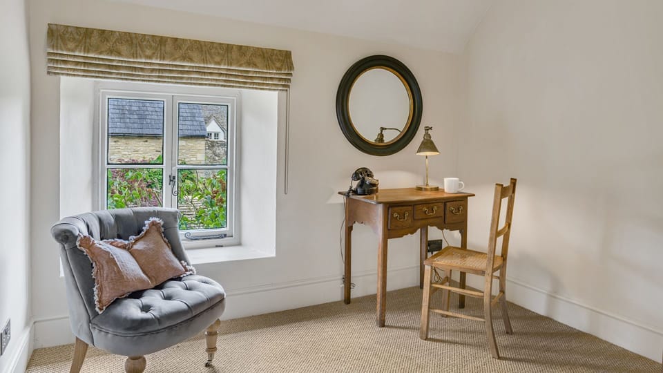 The master bedroom features a dressing table, chair and armchair.