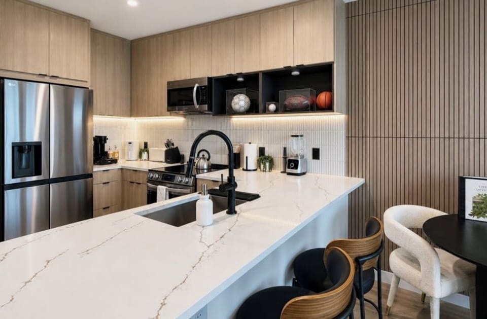 Stylish modern kitchen with quartz island, bar seating, and dining nook