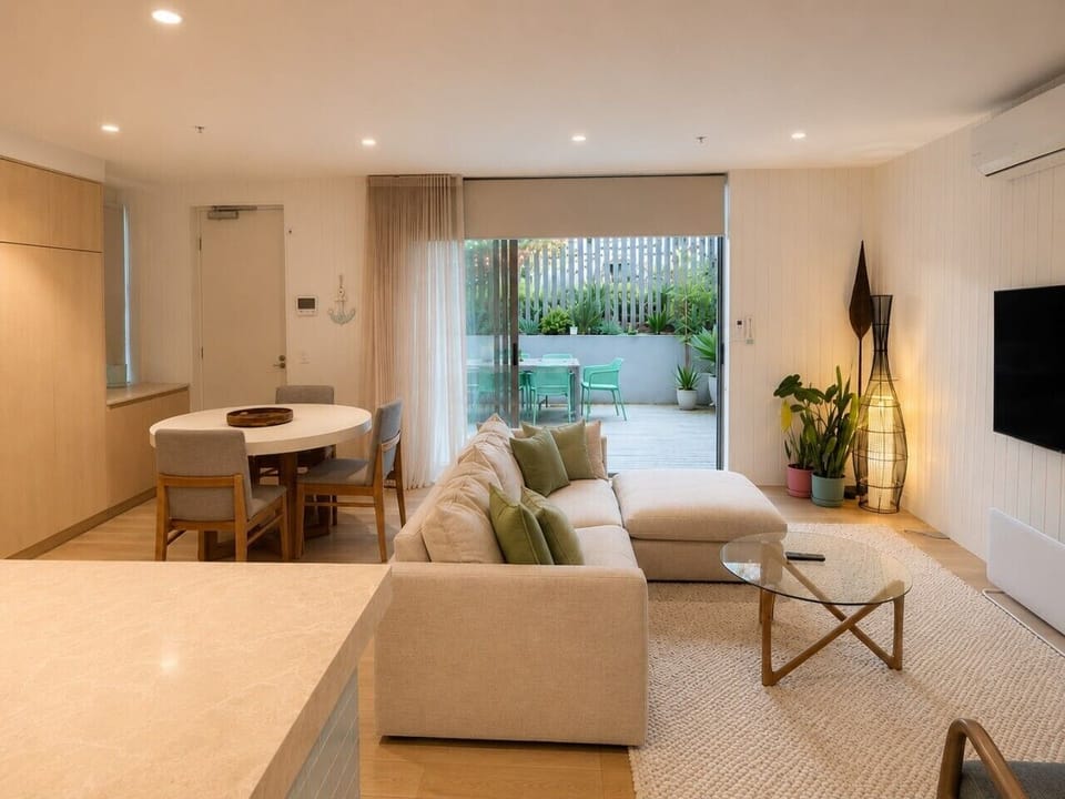 Open-plan living and dining area extending to the private courtyard, offering a bright and welcoming space to relax, dine, and unwind.
