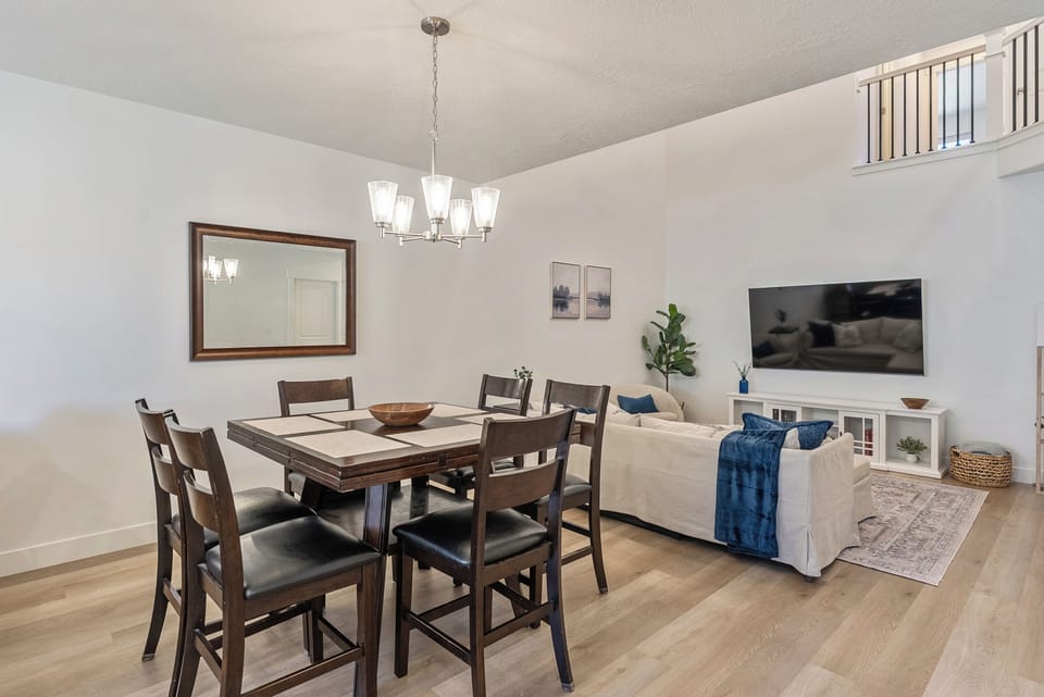 Bright open living & dining space with vaulted ceilings and cozy seating