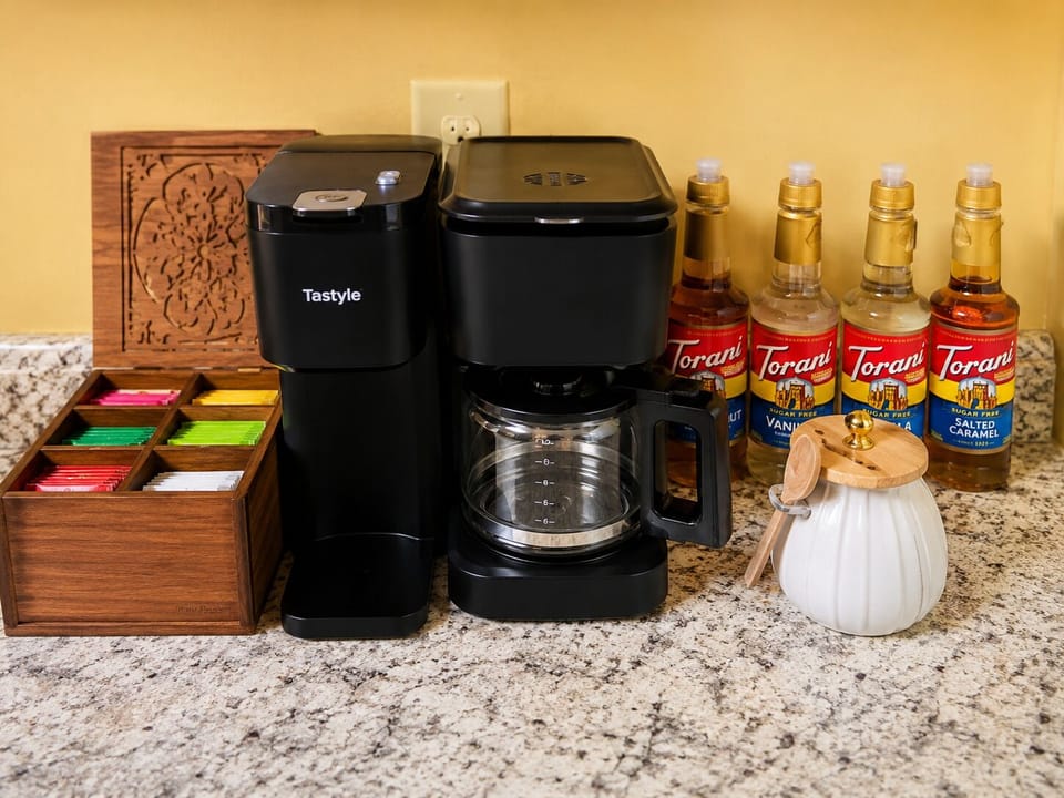 Well-stocked coffee bar with drip, single-serve, tea, and flavored syrups