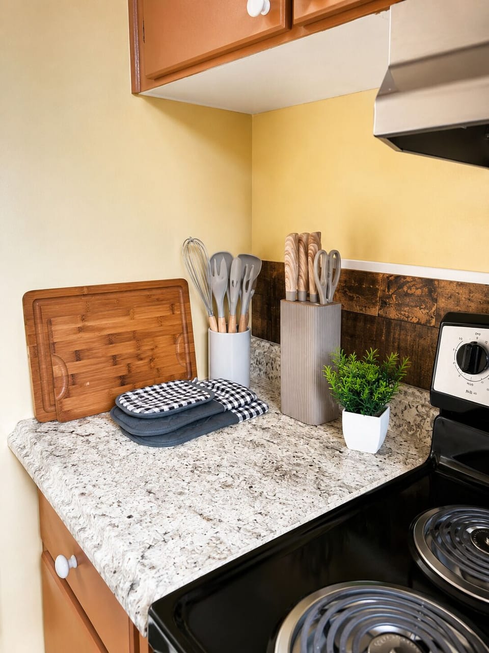 Well-stocked kitchen corner with granite counters and cooking essentials