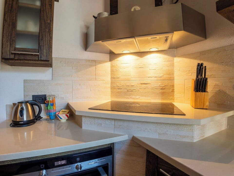 Interior Design, Flooring, Wood, Kitchen, Countertop, Kitchen Appliance, Ceiling, Floor, Cabinetry, Lighting
