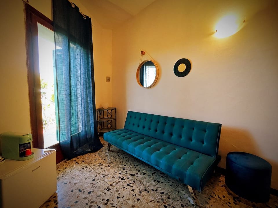 Luxury Triple Room, Sea View | Living area | 32-inch Smart TV with digital channels, streaming services, printers