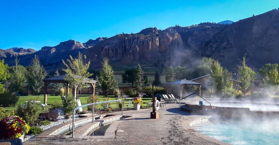 Unwind in steamy mineral water as cliffs glow nearby.