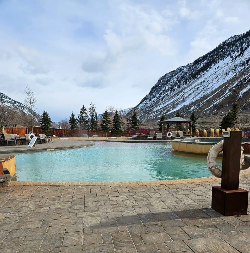 Warm up in winter with serene snowy mountain backdrops.