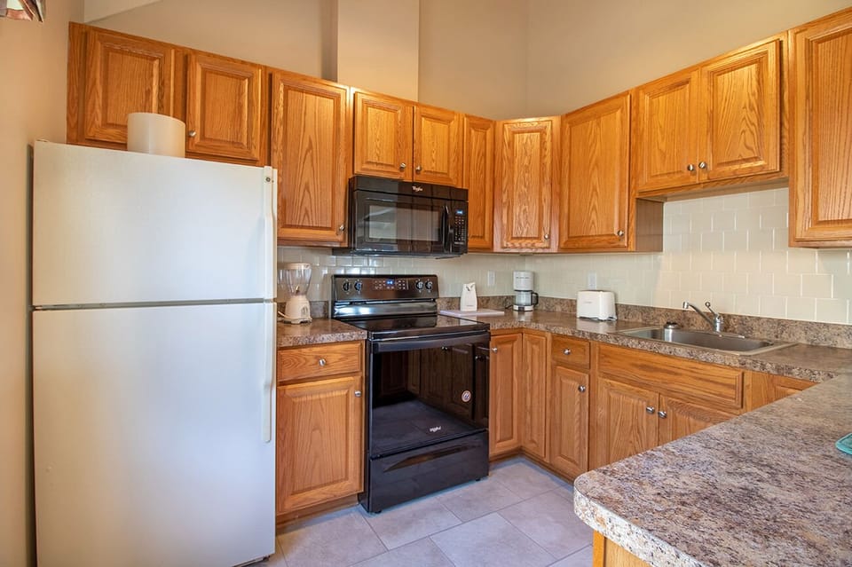 Full Kitchen includes refrigerator, microwave, oven, 