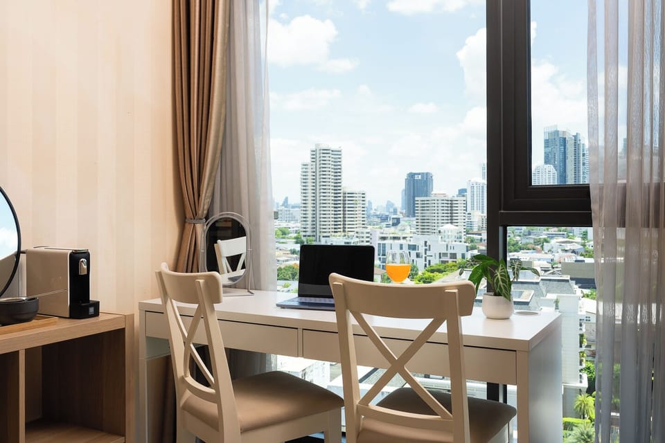 Bright city-view workspace with natural light and a stylish two-seat desk