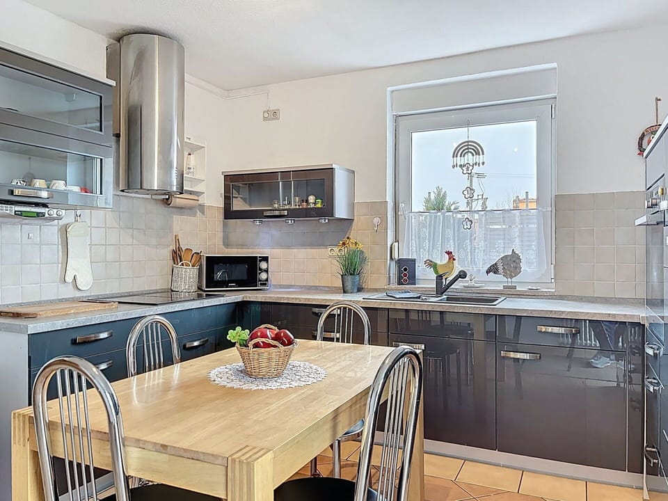 Furniture, Kitchen, Countertop, Kitchen Appliance, Interior Design, Cabinetry, Flooring, Light Fixture, Major Appliance, Lighting