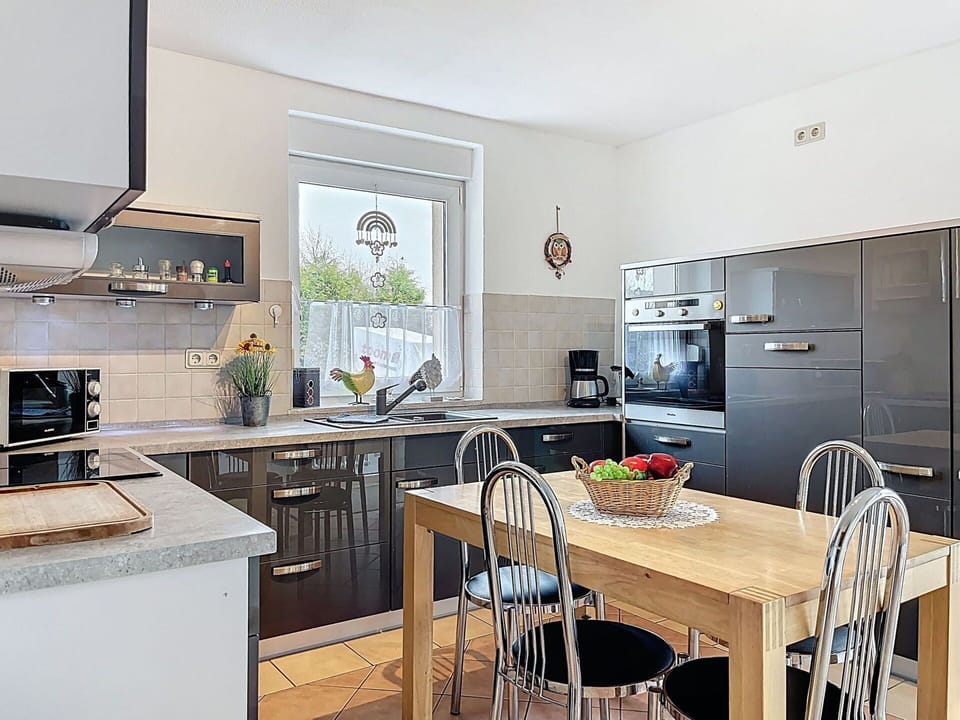 Furniture, Kitchen, Kitchen Appliance, Countertop, Cabinetry, Interior Design, Flooring, Wood, Chair, Major Appliance