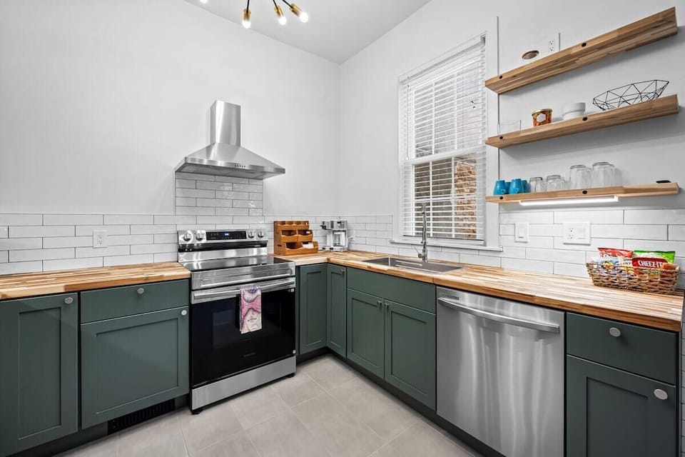 Bright modern kitchen with butcher block counters & stainless appliances