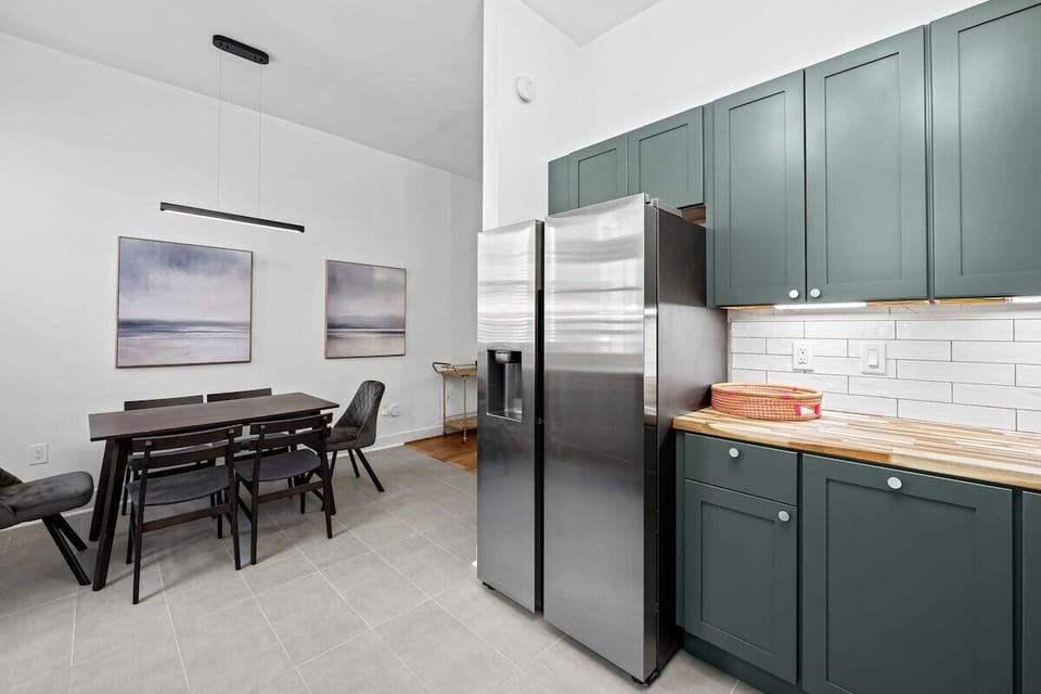 Modern dining area with stylish kitchen, high ceilings, and seating for 6