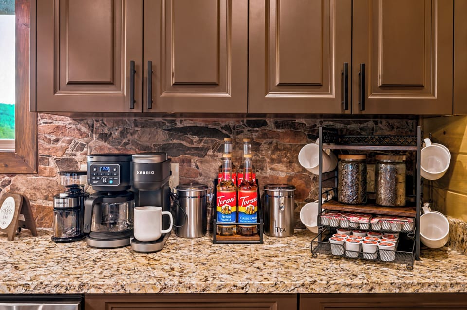 Inviting coffee bar with Keurig, mugs, teas, and flavored syrups