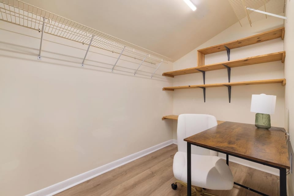 Walk-in closet with built-in shelving and a convenient workspace nook