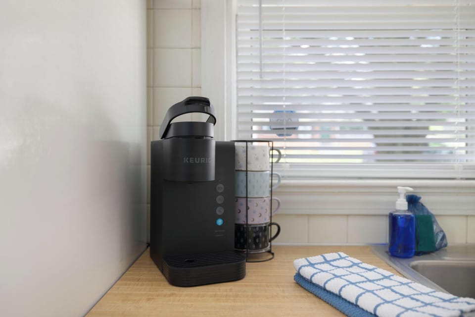 Bright kitchen coffee station with Keurig and mugs ready to enjoy