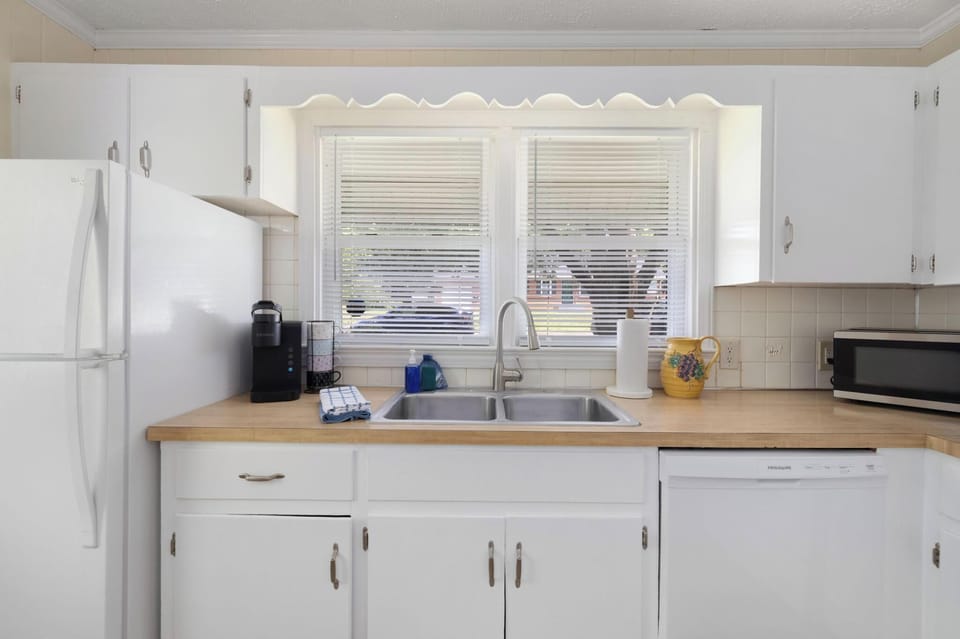 Bright, functional kitchen with sunny windows and full-size appliances