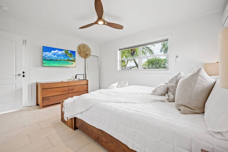 Primary bedroom featuring a king bed, smart TV, and relaxing tropical retreat atmosphere