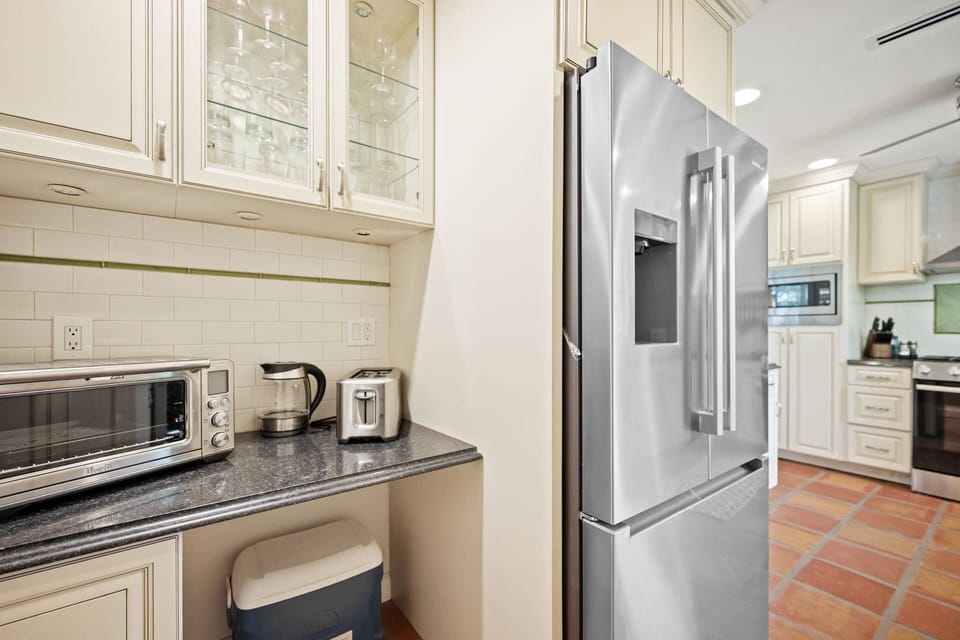 Kitchen workspace with full-size refrigerator and convenient meal prep area