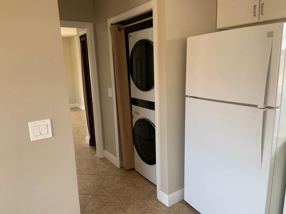 Washer and dryer in the closet next to the kitchen and across from the bathroom 