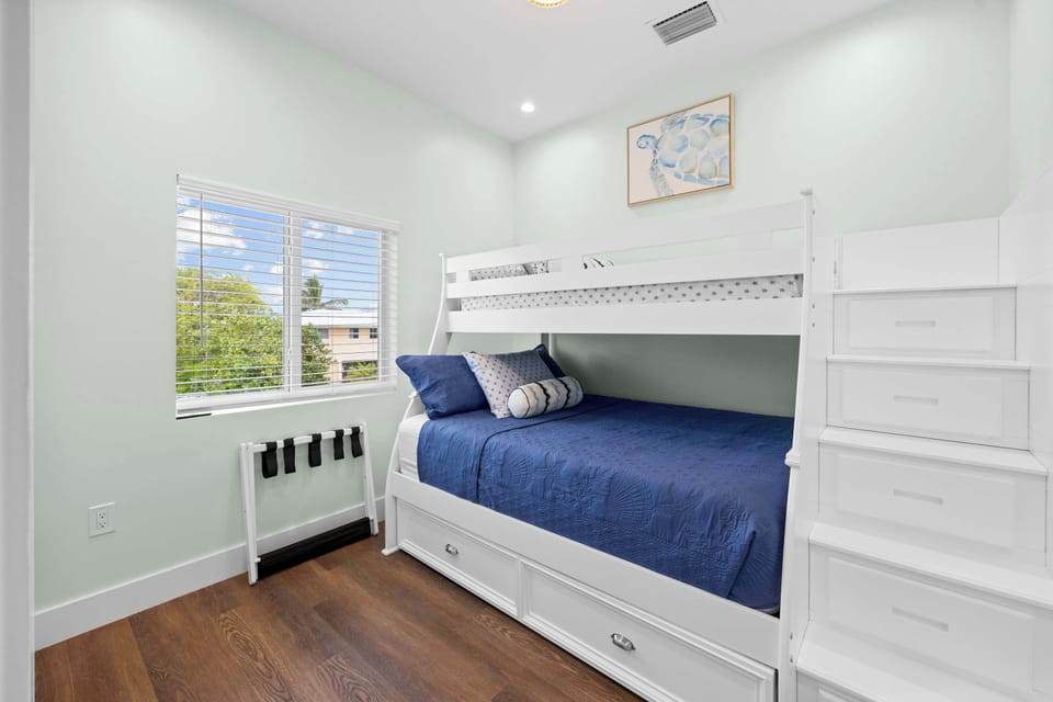 Bunk Room: A twin-over-full bunk with built-in stairs, ready for the kids.