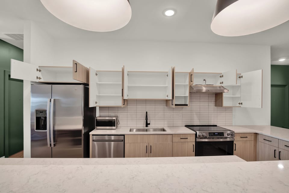 Bright modern kitchen with island, stainless appliances, and stylish finishes