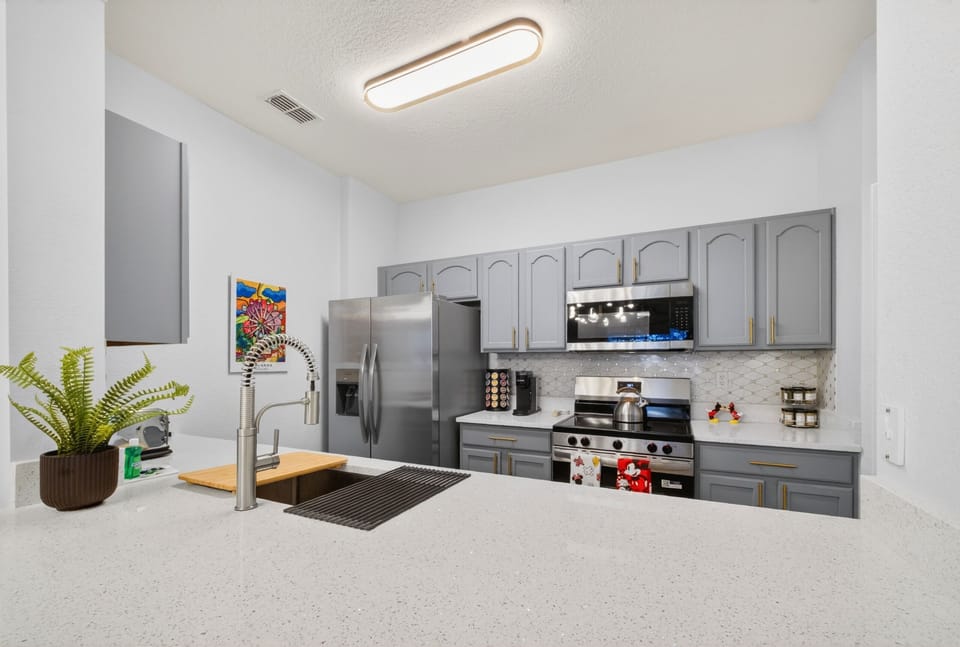Bright modern kitchen with stainless appliances and spacious counters