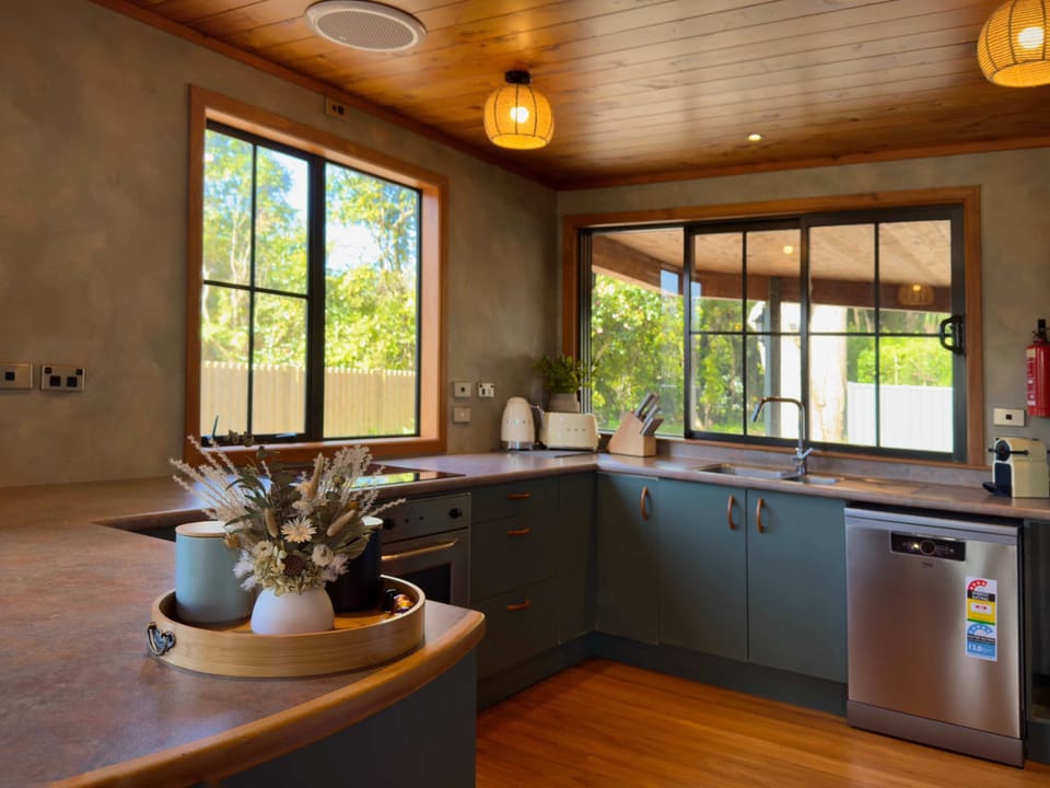 Kitchen with timber and blue-tile splashback