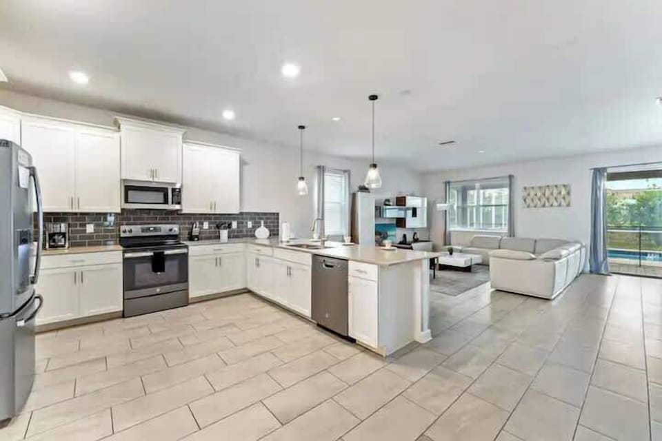 Kitchen: Sleek appliances and abundant light create the perfect culinary escape!