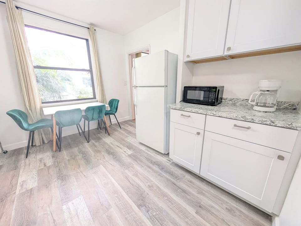 Full kitchen with refrigerator and microwave