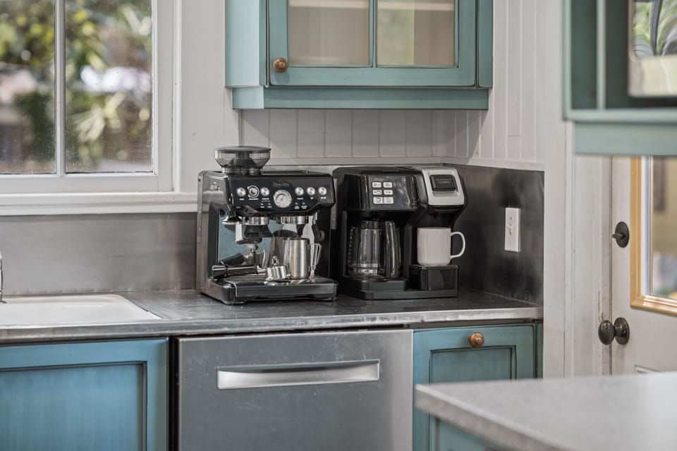 The coffee bar is ready for your morning ritual, with both an espresso machine and a drip coffee maker to start beach days right.