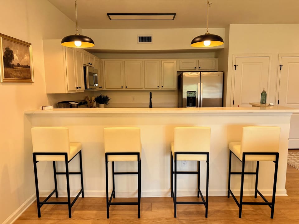 Bright open kitchen with breakfast bar seating for four