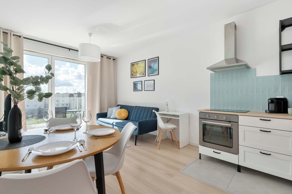 Open-plan living area seamlessly connected to the kitchenette, creating a bright and functional space for relaxation and dining.